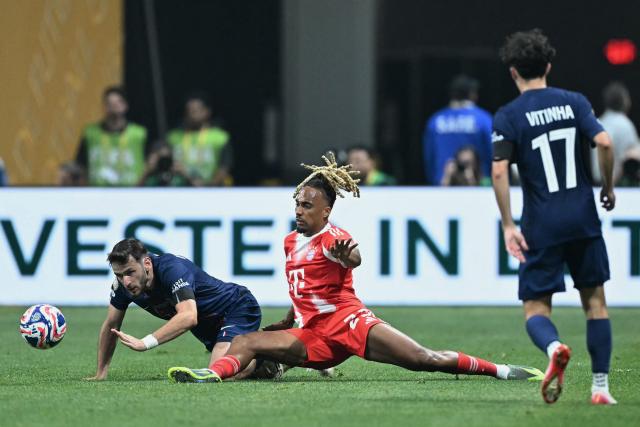 Paris Saint-Germain's Georgian forward #07 Khvicha Kvaratskhelia and Bayern Munich's French defender #23 Sacha Boey fight for the ball during the FIFA Club World Cup 2025 quarterfinal football match between France's Paris Saint-Germain and Germany's Bayern Munich at the Mercedes-Benz Stadium in Atlanta on July 5, 2025. (Photo by PATRICIA DE MELO MOREIRA / AFP)