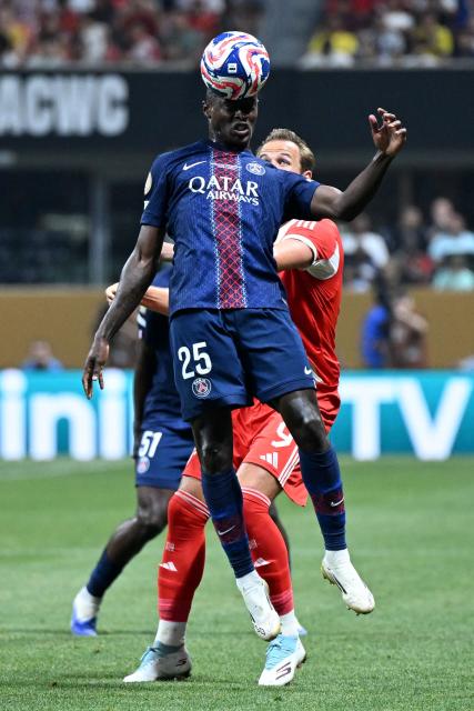 Paris Saint-Germain's Portuguese defender #25 Nuno Mendes and Bayern Munich's English forward #09 Harry Kane fight for the ball during the FIFA Club World Cup 2025 quarterfinal football match between France's Paris Saint-Germain and Germany's Bayern Munich at the Mercedes-Benz Stadium in Atlanta on July 5, 2025. (Photo by PATRICIA DE MELO MOREIRA / AFP)