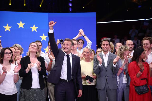 France's President Emmanuel (3L), gestures next President of the French National Assembly Yael Braun-Pivet (2L), France's Minister of Education, Higher Education and Research Elisabeth Borne (4L) and President of Ensemble Pour la Republique parliamentary group Gabriel Attal (front 3R) to during a rally marking the 10th anniversary of "Les Jeunes avec Macron" (Youth with Macron), the youth movement of the Renaissance party, at the Cirque d'Hiver in Paris on July 5, 2025. (Photo by Sebastien DUPUY / AFP)