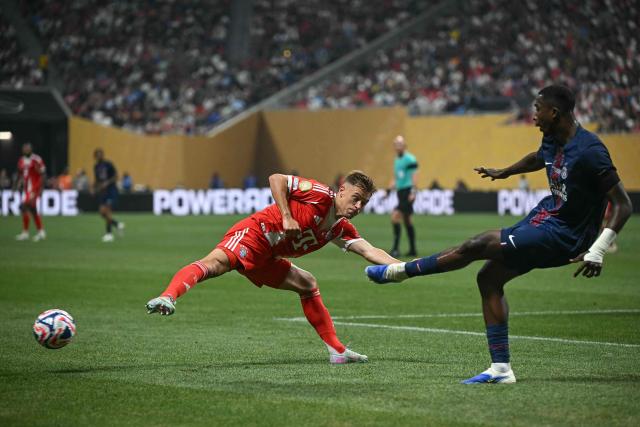 Paris Saint-Germain's Ecuadorian defender #51 William Pacho (R) kicks the ball past Bayern Munich's German midfielder #06 Joshua Kimmich during the FIFA Club World Cup 2025 quarterfinal football match between France's Paris Saint-Germain and Germany's Bayern Munich at the Mercedes-Benz Stadium in Atlanta on July 5, 2025. (Photo by Paul ELLIS / AFP)