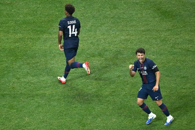 Paris Saint-Germain's French midfielder #14 Desire Doue (L) celebrates with teammate Portuguese midfielder #87 Joao Pedro Goncalves Neves (R) after scoring his team's first goal during the FIFA Club World Cup 2025 quarterfinal football match between France's Paris Saint-Germain and Germany's Bayern Munich at the Mercedes-Benz Stadium in Atlanta on July 5, 2025. (Photo by ROBERTO SCHMIDT / AFP)