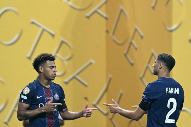 Paris Saint-Germain's French midfielder #14 Desire Doue celebrates scoring the opening goal with Paris Saint-Germain's Moroccan defender #02 Achraf Hakimi during the FIFA Club World Cup 2025 quarterfinal football match between France's Paris Saint-Germain and Germany's Bayern Munich at the Mercedes-Benz Stadium in Atlanta on July 5, 2025. (Photo by PATRICIA DE MELO MOREIRA / AFP)