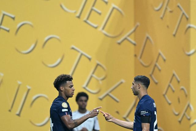 Paris Saint-Germain's French midfielder #14 Desire Doue celebrates scoring the opening goal with Paris Saint-Germain's Moroccan defender #02 Achraf Hakimi during the FIFA Club World Cup 2025 quarterfinal football match between France's Paris Saint-Germain and Germany's Bayern Munich at the Mercedes-Benz Stadium in Atlanta on July 5, 2025. (Photo by PATRICIA DE MELO MOREIRA / AFP)
