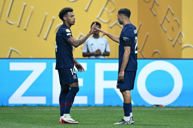 Paris Saint-Germain's French midfielder #14 Desire Doue celebrates scoring the opening goal with Paris Saint-Germain's Moroccan defender #02 Achraf Hakimi during the FIFA Club World Cup 2025 quarterfinal football match between France's Paris Saint-Germain and Germany's Bayern Munich at the Mercedes-Benz Stadium in Atlanta on July 5, 2025. (Photo by PATRICIA DE MELO MOREIRA / AFP)