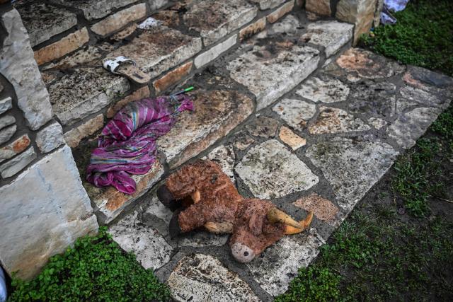 A plush toy sits on the ground outside of a cabin at Camp Mystic, the site of where at least 20 girls went missing after flash flooding in Hunt, Texas, on July 5, 2025. Rescuers were on Saturday searching for more than 20 girls missing from a riverside summer camp in the US state of Texas, after torrential rains caused devastating flooding that killed at least 27 people -- with more rain on the way. "So far, we've evacuated over 850 uninjured people, eight injured people and have recovered 27 deceased fatalities at this time. Of these 27, 18 are adults, nine are children," said Kerr Country Sheriff Larry Leitha on July 5. (Photo by RONALDO SCHEMIDT / AFP)