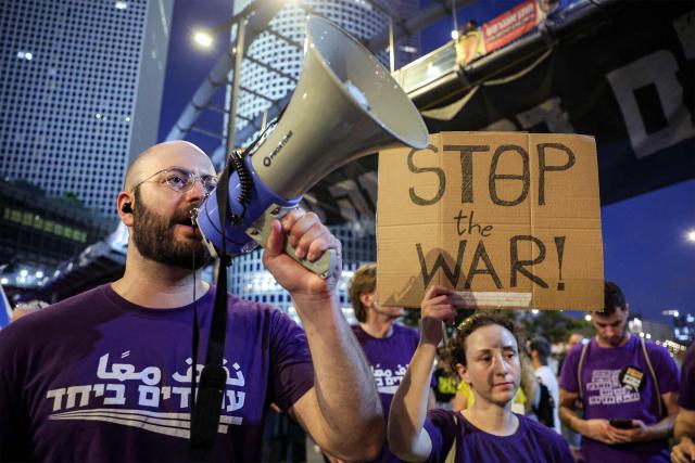 Demonstrators gather during an anti-government protest calling for action to secure the release of Israeli hostages held captive in the Gaza Strip by Palestinian militants since the 2023 October 7 attacks, outside the Israeli Defence Ministry headquarters in Tel Aviv on July 5, 2025. (Photo by Jack GUEZ / AFP)