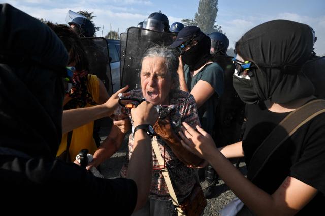 An elderly woman receives treatment for teargas after being pushed away by the police as protestors clash with police during a demonstration dubbed "Turbo-Teuf" against the A69 motorway project, in Morens-Scopont, southern France, on July 5, 2025. Environmental groups are holding a protest in the Tarn deparment against the construction of the Toulouse-Castres A69 motorway, despite the gathering's ban by authorities. (Photo by Ed JONES / AFP)