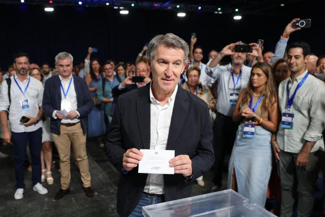 Spain's opposition right-wing Popular Party (PP) leader Alberto Nunez Feijoo holds his ballot showing his name as he votes at the PP national congress in Madrid on July 5, 2025. (Photo by Thomas COEX / AFP)