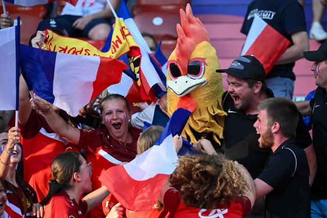 Fans of France wave national flags as they cheer on their team ahead of the UEFA Women's Euro 2025 Group D football match between France and England at the Letzigrund Stadium in Zurich, on July 5, 2025. (Photo by SEBASTIEN BOZON / AFP)