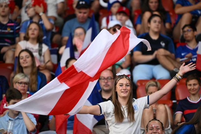 A fan of England waves a national flags as she cheers on her team ahead of the UEFA Women's Euro 2025 Group D football match between France and England at the Letzigrund Stadium in Zurich, on July 5, 2025. (Photo by SEBASTIEN BOZON / AFP)