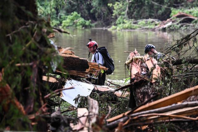 Members of a search and rescue team look for people near Camp Mystic, the site of where at least 20 girls went missing after flash flooding in Hunt, Texas, on July 5, 2025. Rescuers were on Saturday searching for more than 20 girls missing from a riverside summer camp in the US state of Texas, after torrential rains caused devastating flooding that killed at least 27 people -- with more rain on the way. "So far, we've evacuated over 850 uninjured people, eight injured people and have recovered 27 deceased fatalities at this time. Of these 27, 18 are adults, nine are children," said Kerr Country Sheriff Larry Leitha on July 5. (Photo by RONALDO SCHEMIDT / AFP)