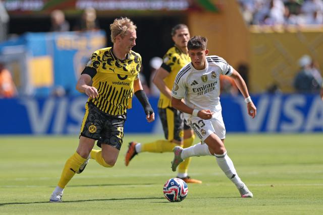 Borussia Dortmund's German midfielder #10 Julian Brandt (L) fights for the ball with Real Madrid's Turkish midfielder #15 Arda Guler during the FIFA Club World Cup 2025 quarterfinal football match between Spain's Real Madrid and Germany's Borussia Dortmund at the MetLife stadium in East Rutherford, New Jersey on July 5, 2025. (Photo by CHARLY TRIBALLEAU / AFP)