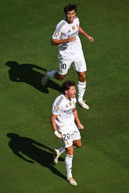 Real Madrid's Spanish defender #20 Francisco Garcia (B) celebrates with teammate Spanish forward #30 Gonzalo Garcia (T) after scoring his team's second goal during the FIFA Club World Cup 2025 quarterfinal football match between Spain's Real Madrid and Germany's Borussia Dortmund at the MetLife stadium in East Rutherford, New Jersey on July 05, 2025. (Photo by ANGELA WEISS / AFP)