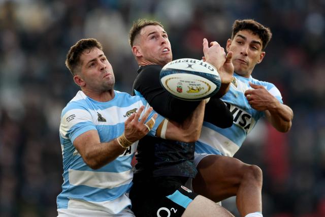 England's wing Tom Roebuck jumps for the ball between Argentina's wing Ignacio Mendy and Argentina's full back Santiago Carreras during the international rugby test match between Argentina and England at the Jorge Luis Hirschi Stadium in La Plata, Buenos Aires province, Argentina, on July 5, 2025. (Photo by ALEJANDRO PAGNI / AFP)