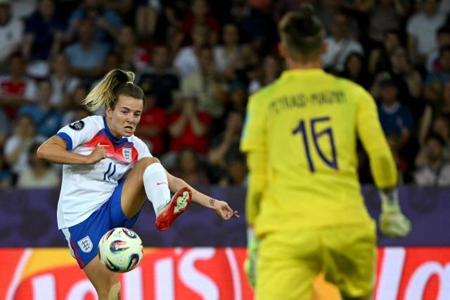 England's forward #11 Lauren Hemp kicks the ball towards France's goalkeeper #16 Pauline Peyraud-Magnin during the UEFA Women's Euro 2025 Group D football match between France and England at the Letzigrund Stadium in Zurich, on July 5, 2025. (Photo by Miguel MEDINA / AFP)