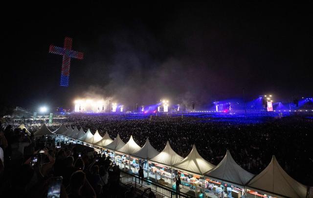 Drones create a cross during concert a concert of Croatian nationalist singer Marko Perkovic Thompson at the Zagreb hippodrome, who is known for his sympathies for the country's World War II Nazi-allied regime, to an expected by a crowd of some 450,000 people, in Zagreb, on July 5, 2025. (Photo by DAMIR SENCAR / AFP)