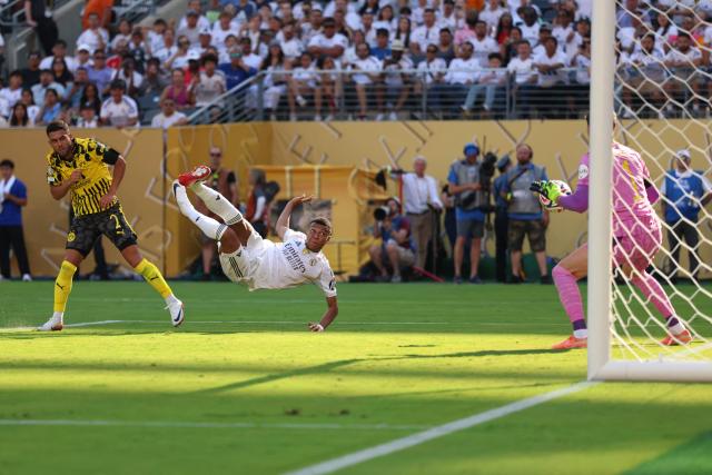 Borussia Dortmund's Brazilian defender #02 Yan Couto fights for the ball with Real Madrid's French forward #09 Kylian Mbappe as he scores his team's third goal during the FIFA Club World Cup 2025 quarterfinal football match between Spain's Real Madrid and Germany's Borussia Dortmund at the MetLife stadium in East Rutherford, New Jersey on July 5, 2025. (Photo by CHARLY TRIBALLEAU / AFP)