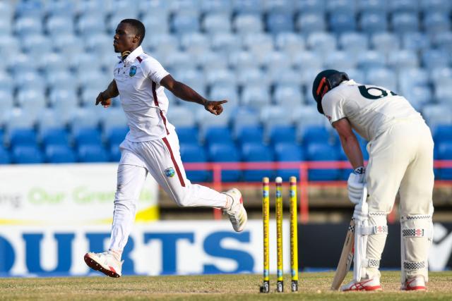 Travis Head (R) of Australia is bowled out by Shamar Joseph (L) of West Indies during the 3rd day of the 2nd Test match between West Indies and Australia at Grenada National Cricket Stadium, Saint George's, Grenada, on July 5, 2025. (Photo by Randy Brooks / AFP)
