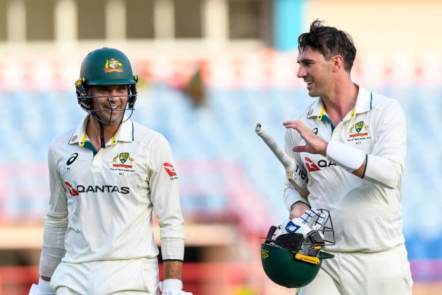 Alex Carey (L) and Pat Cummins (R) of Australia walk off the field at the end of  the 3rd day of the 2nd Test match between West Indies and Australia at Grenada National Cricket Stadium, Saint George's, Grenada, on July 5, 2025. (Photo by Randy Brooks / AFP)
