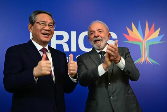 Brazil's President Luiz Inacio Lula da Silva (R) and China's Premier Li Qiang gesture after a bilateral meeting ahead of the BRICS summit in Rio de Janeiro, Brazil, on July 5, 2025. BRICS leaders meeting in Rio de Janeiro from Sunday are expected to decry Donald Trump's hardline trade policies, but are struggling to bridge divides over crises roiling the Middle East. (Photo by Pablo PORCIUNCULA / AFP)
