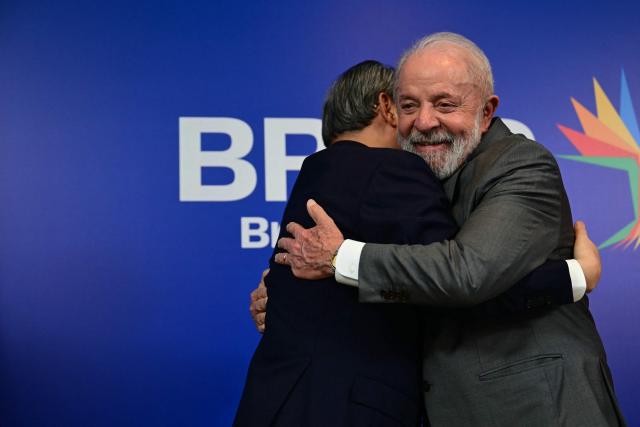 Brazil's President Luiz Inacio Lula da Silva (R) hugs China's Premier Li Qiang after a bilateral meeting ahead of the BRICS summit in Rio de Janeiro, Brazil, on July 5, 2025. BRICS leaders meeting in Rio de Janeiro from Sunday are expected to decry Donald Trump's hardline trade policies, but are struggling to bridge divides over crises roiling the Middle East. (Photo by Pablo PORCIUNCULA / AFP)