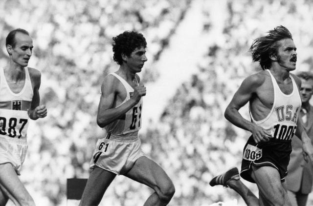 (FILES) (From L) Germany's Harald Norpoth, Belgium's Emiel Puttemans and USA's Steve Prefontaine compete in the second heat of the 5000 metres during the Olympic Games in Munich on September 8, 1972. The legacy of American runner Steve Prefontaine, an icon of the track in the 1970s, remains strong in Eugene, Oregon, 50 years after his death, where he continues to captivate witnesses of the time and younger generations. (Photo by EPU / AFP)