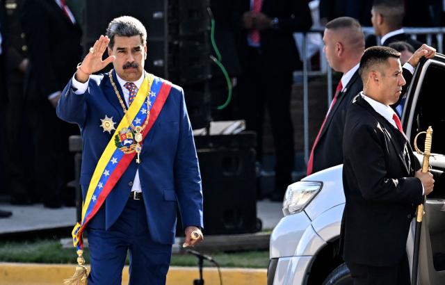 Venezuela's President Nicolas Maduro waves during celebrations for the Independence Day, in Caracas on July 5, 2025. (Photo by Juan BARRETO / AFP)