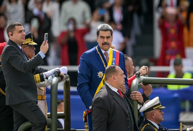 Venezuela's President Nicolas Maduro parades in a military vehicle during celebrations for the Independence Day, in Caracas on July 5, 2025. (Photo by Juan BARRETO / AFP)