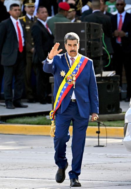 Venezuela's President Nicolas Maduro waves during celebrations for the Independence Day, in Caracas on July 5, 2025. (Photo by Juan BARRETO / AFP)