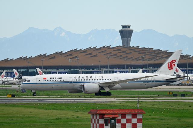 An Air China Boeing 787-9 Dreamliner(front) plane waits to take off at Beijing International airport on July 6, 2025. (Photo by WANG Zhao / AFP)
