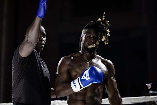 A referee sends Senegalese kickboxer and World Champion Mouhamed Tafsir Ba back to his corner after finishing one round during his fight against Swiss kickboxer Eric Brito (unseen) for the World Association of Kickboxing Organizations (WAKO) pro Intercontinental Belt in the 86kg category at the Grand Theater in Dakar, on July 6, 2025. (Photo by PATRICK MEINHARDT / AFP)