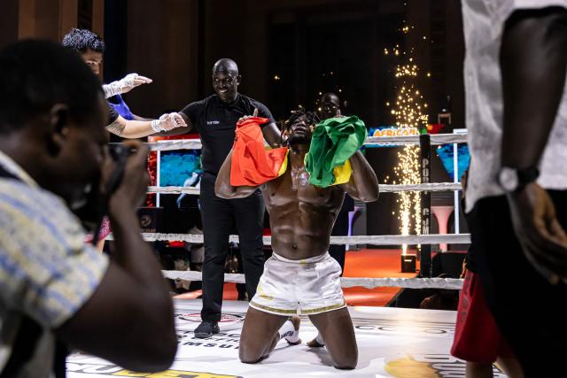 Senegalese kickboxer and World Champion Mouhamed Tafsir Ba (C) celebrates after winning against Swiss kickboxer Eric Brito (unseen) during their fight for the World Association of Kickboxing Organizations (WAKO) pro Intercontinental Belt in the 86kg category at the Grand Theater in Dakar, on July 6, 2025. (Photo by PATRICK MEINHARDT / AFP)