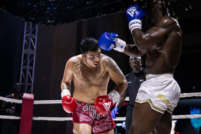 Senegalese kickboxer and World Champion Mouhamed Tafsir Ba (R) competes against Swiss kickboxer Eric Brito (L) during their fight for the World Association of Kickboxing Organizations (WAKO) pro Intercontinental Belt in the 86kg category at the Grand Theater in Dakar, on July 6, 2025. (Photo by PATRICK MEINHARDT / AFP)