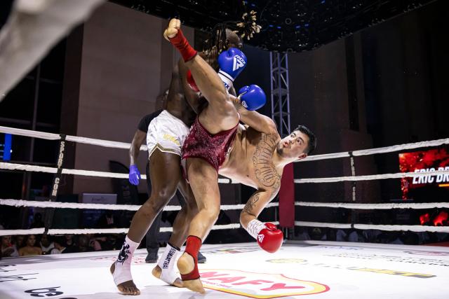 Senegalese kickboxer and World Champion Mouhamed Tafsir Ba (L) competes against Swiss kickboxer Eric Brito (R) during their fight for the World Association of Kickboxing Organizations (WAKO) pro Intercontinental Belt in the 86kg category at the Grand Theater in Dakar, on July 6, 2025. (Photo by PATRICK MEINHARDT / AFP)
