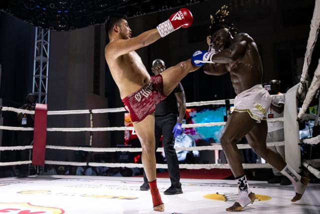 Senegalese kickboxer and World Champion Mouhamed Tafsir Ba (R) competes against Swiss kickboxer Eric Brito (L) during their fight for the World Association of Kickboxing Organizations (WAKO) pro Intercontinental Belt in the 86kg category at the Grand Theater in Dakar, on July 6, 2025. (Photo by PATRICK MEINHARDT / AFP)