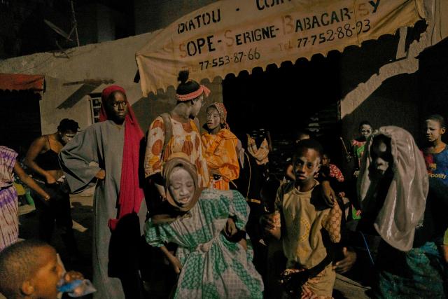 Women and children in costume parade in the street as part of the Tamkharite celebration in Medina, Dakar, Senegal, on July 5, 2025. In Senegal, a predominantly Sunni Muslim country, Ashura is celebrated as Tamkharite, blending religion and local culture. Religiously, it commemorates the day Allah saved Prophet Moses (Moussa), and many Sunni Muslims fast in gratitude.Families prepare special millet couscous, and children celebrate Tajabone, dressing up and singing for treats. (Photo by Carmen Abd Ali / AFP)