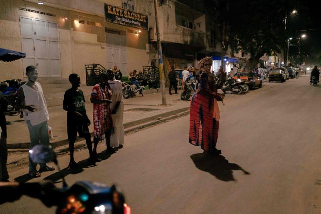 A woman in costume parades in the street as part of the Tamkharite celebration in Grand Dakar, Senegal, on July 5, 2025. In Senegal, a predominantly Sunni Muslim country, Ashura is celebrated as Tamkharite, blending religion and local culture. Religiously, it commemorates the day Allah saved Prophet Moses (Moussa), and many Sunni Muslims fast in gratitude.Families prepare special millet couscous, and children celebrate Tajabone, dressing up and singing for treats. (Photo by Carmen Abd Ali / AFP)