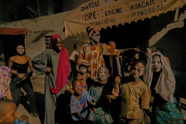 Women and children in costume parade in the street as part of the Tamkharite celebration in Medina, Dakar, Senegal, on July 5, 2025. In Senegal, a predominantly Sunni Muslim country, Ashura is celebrated as Tamkharite, blending religion and local culture. Religiously, it commemorates the day Allah saved Prophet Moses (Moussa), and many Sunni Muslims fast in gratitude.Families prepare special millet couscous, and children celebrate Tajabone, dressing up and singing for treats. (Photo by Carmen Abd Ali / AFP)