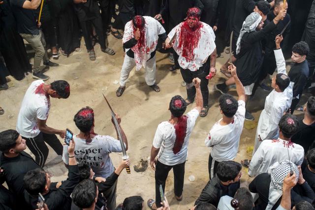 Shiite Muslim men take part in the Tatbir bloodletting ritual, an act of mourning marking Ashura, a 10-day period commemorating the seventh century killing of Prophet Mohammed's grandson Imam Hussein, in Iraq's central holy city of Najaf on July 5, 2025. (Photo by Qassem al-KAABI / AFP)