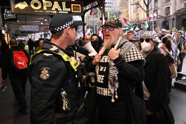 Police and protesters exchange words during a pro-Palestinian march through the streets of Melbourne on July 6, 2025, amid the ongoing conflict between Israel and the Palestinian Hamas militant group. (Photo by William WEST / AFP)