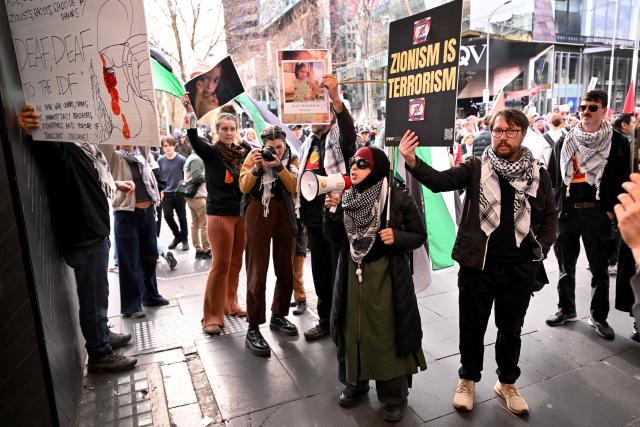 People protest outside a McDonalds restaurant during a pro-Palestinian march through the streets of Melbourne on July 6, 2025, amid the ongoing conflict between Israel and the Palestinian Hamas militant group. (Photo by William WEST / AFP)