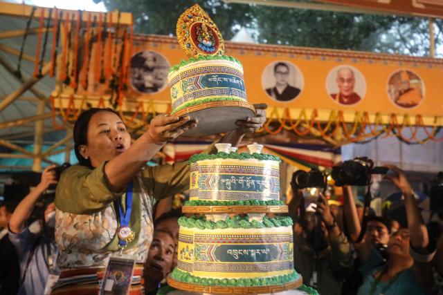 A volunteer prepares a cake during a prayer ceremony celebrating the 90th birth anniversary of Tibetan spiritual leader the Dalai Lama at the Main Tibetan Temple in McLeod Ganj, near Dharamsala, on July 6, 2025. Calling himself a "simple Buddhist monk" who usually didn't celebrate birthdays, the Dalai Lama marked his 90th on July 6 by praying for peace after China insisted it would have final say on who succeeded the Tibetan spiritual leader. (Photo by Sanjay BAID / AFP)