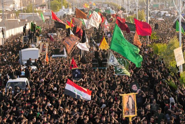 Iraqi Shiite Muslims take part in a procession during a mourning ritual to mark Ashura, a 10-day period commemorating the seventh century killing of Prophet Mohammed's grandson Imam Hussein, in Nasiriyah, in Iraq's southern Dhi Qar province early on July 6, 2025. (Photo by Asaad NIAZI / AFP)