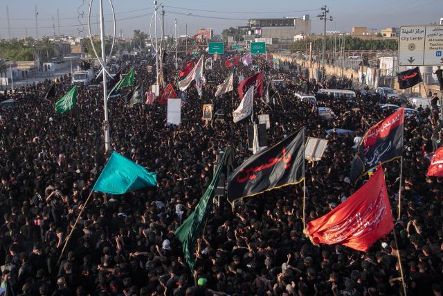 Iraqi Shiite Muslims take part in a procession during a mourning ritual to mark Ashura, a 10-day period commemorating the seventh century killing of Prophet Mohammed's grandson Imam Hussein, in Nasiriyah, in Iraq's southern Dhi Qar province early on July 6, 2025. (Photo by Asaad NIAZI / AFP)