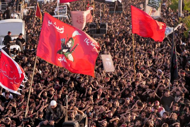 Iraqi Shiite Muslims beat their heads as they take part in a mourning ritual to mark Ashura, a 10-day period commemorating the seventh century killing of Prophet Mohammed's grandson Imam Hussein, in Nasiriyah, in Iraq's southern Dhi Qar province early on July 6, 2025. (Photo by Asaad NIAZI / AFP)