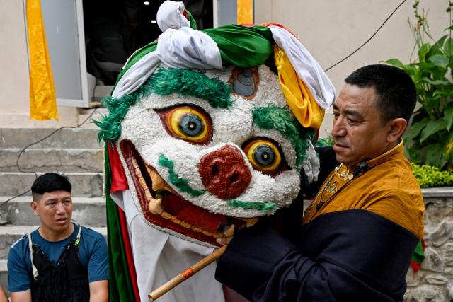 Exiled Tibetan performers wait backstage during celebrations held to mark the 90th birthday of their spiritual leader the Dalai Lama, at a Tibetan refugee camp in the Jawalakhel area of Lalitpur, on the outskirts of Kathmandu on July 6, 2025. Calling himself a "simple Buddhist monk" who usually doesn't celebrate birthdays, the Dalai Lama marked his 90th on July 6, by praying for peace after China insisted it would have the final say on who succeeded the Tibetan spiritual leader. (Photo by Prakash MATHEMA / AFP)
