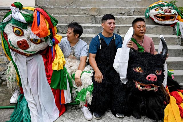 Exiled Tibetan performers wait backstage during celebrations held to mark the 90th birthday of their spiritual leader the Dalai Lama, at a Tibetan refugee camp in the Jawalakhel area of Lalitpur, on the outskirts of Kathmandu on July 6, 2025. Calling himself a "simple Buddhist monk" who usually doesn't celebrate birthdays, the Dalai Lama marked his 90th on July 6, by praying for peace after China insisted it would have the final say on who succeeded the Tibetan spiritual leader. (Photo by Prakash MATHEMA / AFP)