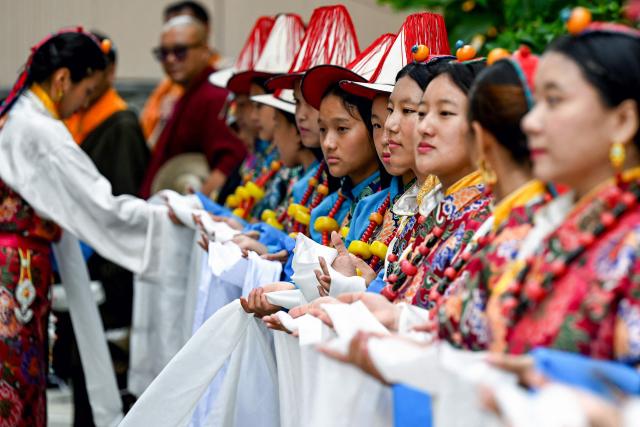 Exiled Tibetans take part in a procession to celebrate the 90th birthday of their spiritual leader the Dalai Lama, at a Tibetan refugee camp in the Jawalakhel area of Lalitpur, on the outskirts of Kathmandu on July 6, 2025. Calling himself a "simple Buddhist monk" who usually doesn't celebrate birthdays, the Dalai Lama marked his 90th on July 6, by praying for peace after China insisted it would have the final say on who succeeded the Tibetan spiritual leader. (Photo by Prakash MATHEMA / AFP)