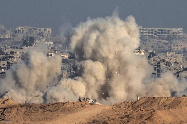 This picture taken from a position near Israel's border with the Gaza Strip, shows smoke and debris billowing during an Israeli strike on the besieged territory on July 6, 2025. An Israeli delegation was expected in Doha on July 6 for talks on a Gaza truce and hostage release deal, ahead of a visit by Prime Minister Benjamin Netanyahu to the White House. (Photo by Maya Levin / AFP)