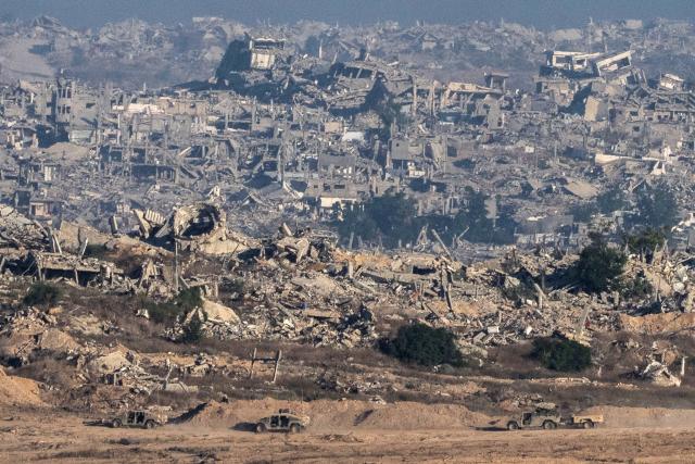 This picture taken from a position near Israel's border with the Gaza Strip, shows Israeli army vehicles inside the the besieged territory on July 6, 2025. An Israeli delegation was expected in Doha on July 6 for talks on a Gaza truce and hostage release deal, ahead of a visit by Prime Minister Benjamin Netanyahu to the White House. (Photo by Maya Levin / AFP)